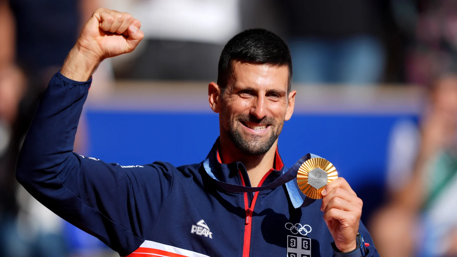 Djokovic with the celebratory pose with his Olympic Gold Medal