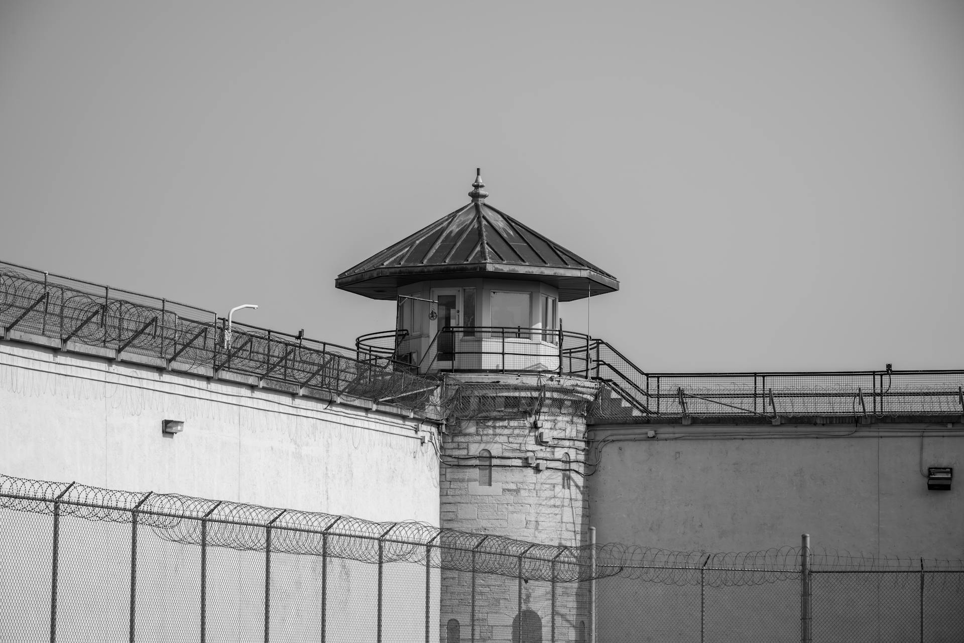 A black and white photo of a prison tower
